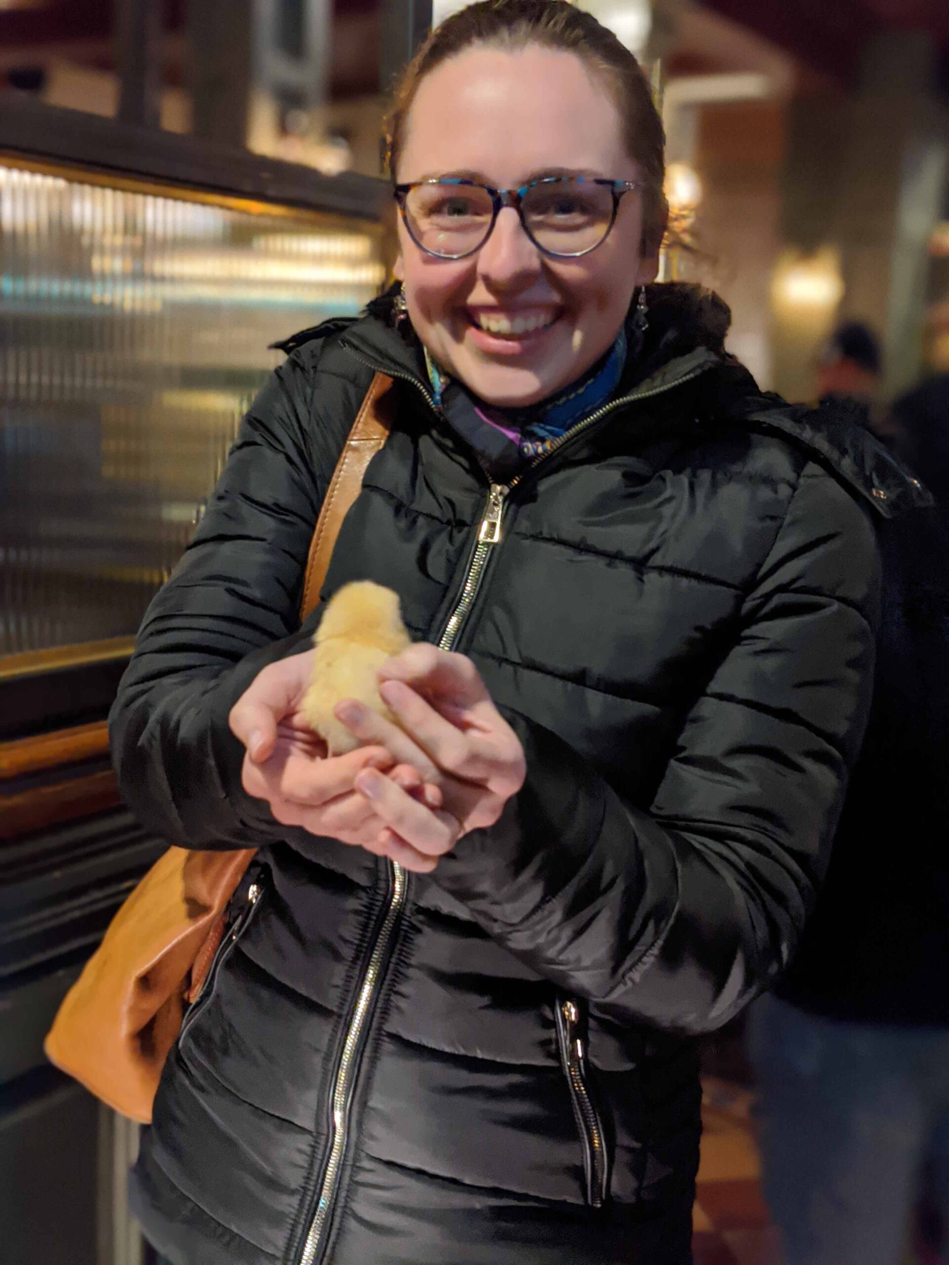Zoe beams with happiness holding a baby chick